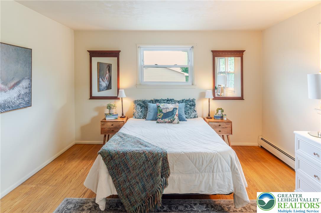 2130 Wisteria Road Lower Macungie Township, PA 18062 - Photo 32 of 48 Hardwood floors and a well-lit window create a bright and comfortable sleeping area.