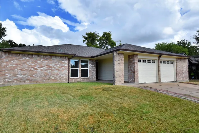 a front view of a house with a garden and yard