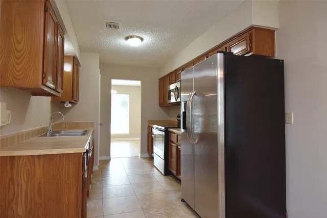 a kitchen with a refrigerator and a sink