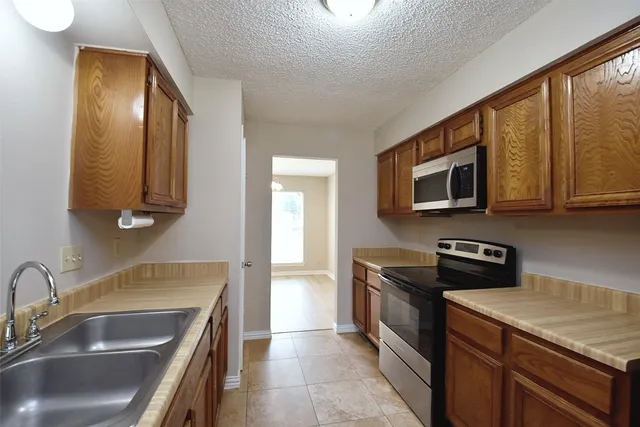 a kitchen that has a sink and a stove