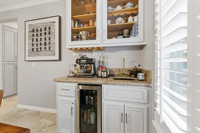 a kitchen with stainless steel appliances granite countertop white cabinets granite counter tops and a window
