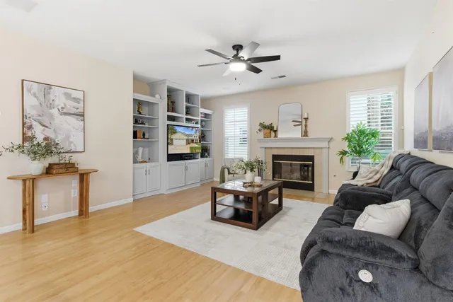 a living room with furniture a window and a chandelier