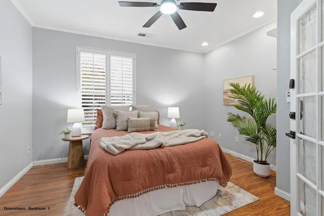 a bedroom with a bed and wooden floor