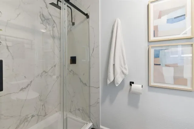 a bathroom with a tub sink and mirror