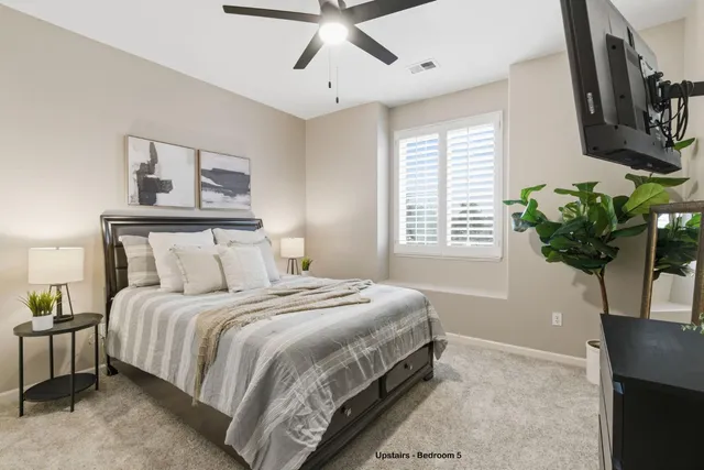 a backyard of a house with table and chairs