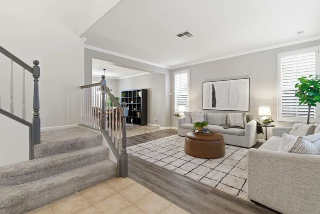 a living room with furniture and a dining table