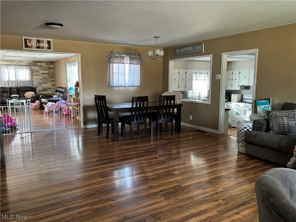 125 Sundale Road Norwich, OH 43767 - Photo 3 of 18 Dining space featuring a wealth of natural light, dark hardwood / wood-style floors, and a notable chandelier