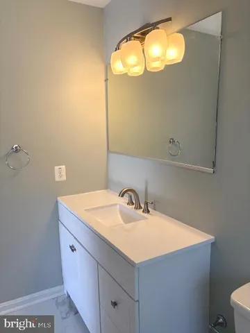 a bathroom with a sink vanity and a mirror
