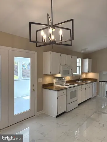 a kitchen with stainless steel appliances granite countertop a sink and cabinets