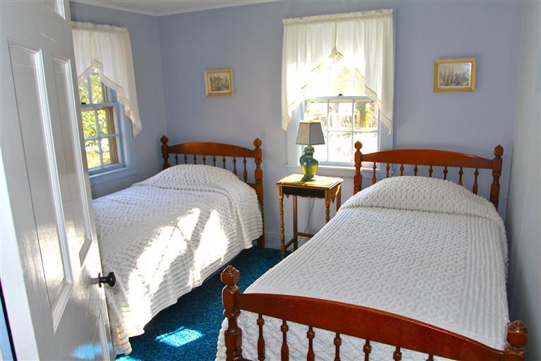 575 Great Pond Road Eastham, MA 02642 - Photo 16 of 23 a bed sitting in a bedroom next to a window