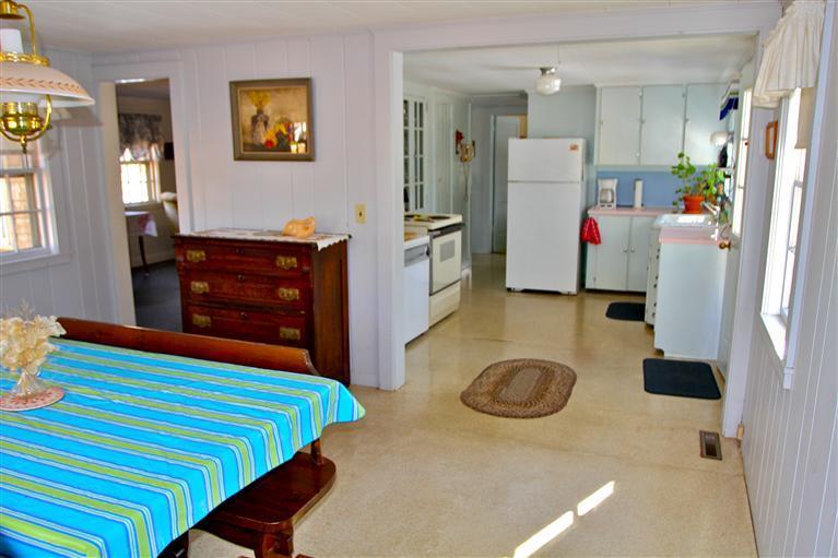 575 Great Pond Road Eastham, MA 02642 - Photo 10 of 23 a bedroom with a bed and a chandelier