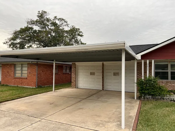 front view of a house with a yard and garage