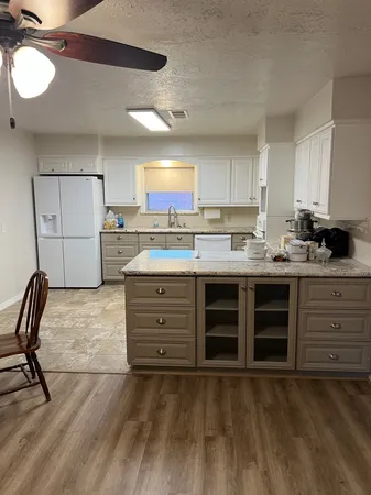 a kitchen with a stove a sink and a refrigerator