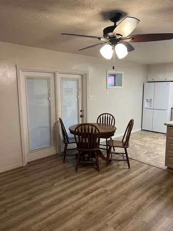 a view of a dining room with furniture and wooden floor
