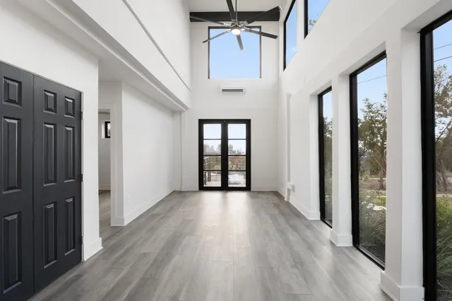 wooden floor in an empty room with a window