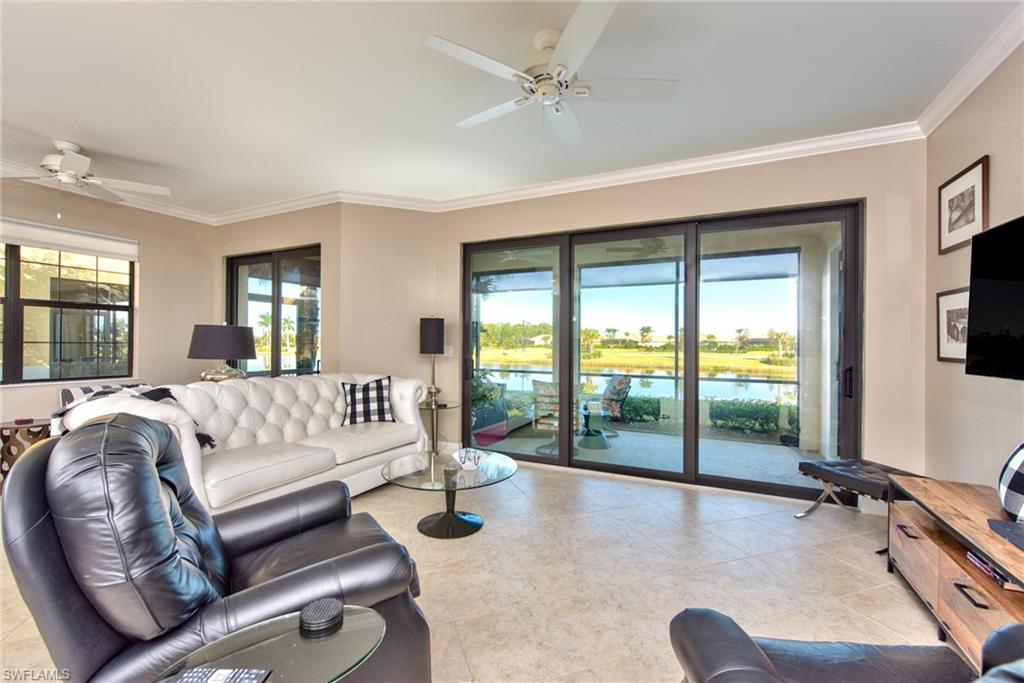 10470 Casella Way, Unit 101 Fort Myers, FL 33913 - Photo 11 of 34 a spacious bedroom with a large bed and a balcony view