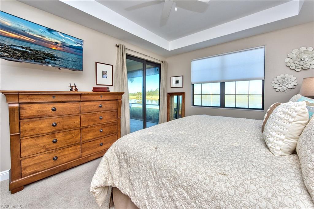 10470 Casella Way, Unit 101 Fort Myers, FL 33913 - Photo 14 of 34 a bedroom with a bed and a mirror on dresser