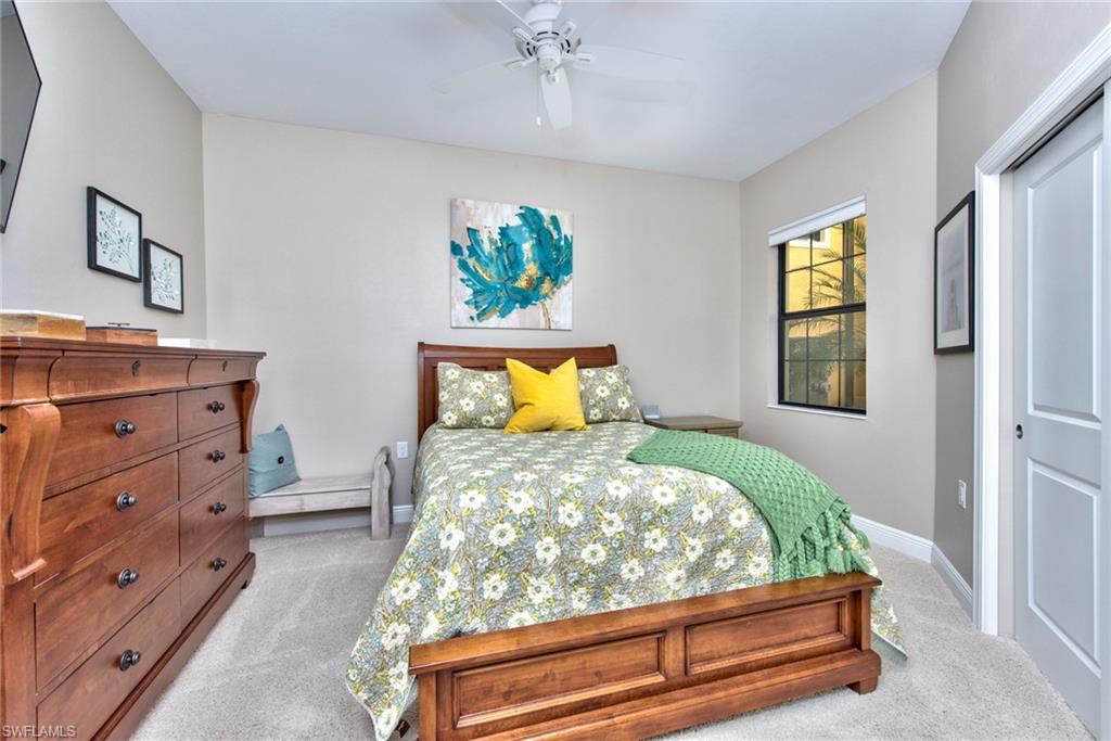 10470 Casella Way, Unit 101 Fort Myers, FL 33913 - Photo 16 of 34 a bed sitting in a bedroom next to a window