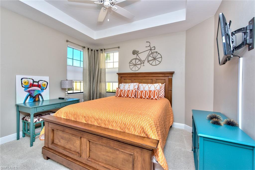 10470 Casella Way, Unit 101 Fort Myers, FL 33913 - Photo 17 of 34 a bedroom with a bed and a table in it