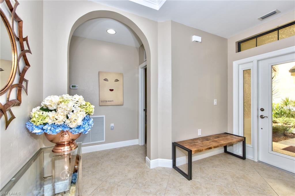 10470 Casella Way, Unit 101 Fort Myers, FL 33913 - Photo 6 of 34 a living room filled with furniture and a chandelier