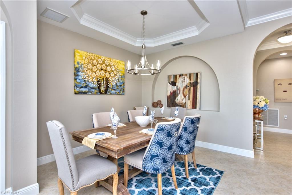 10470 Casella Way, Unit 101 Fort Myers, FL 33913 - Photo 7 of 34 a view of a dining room with furniture and chandelier