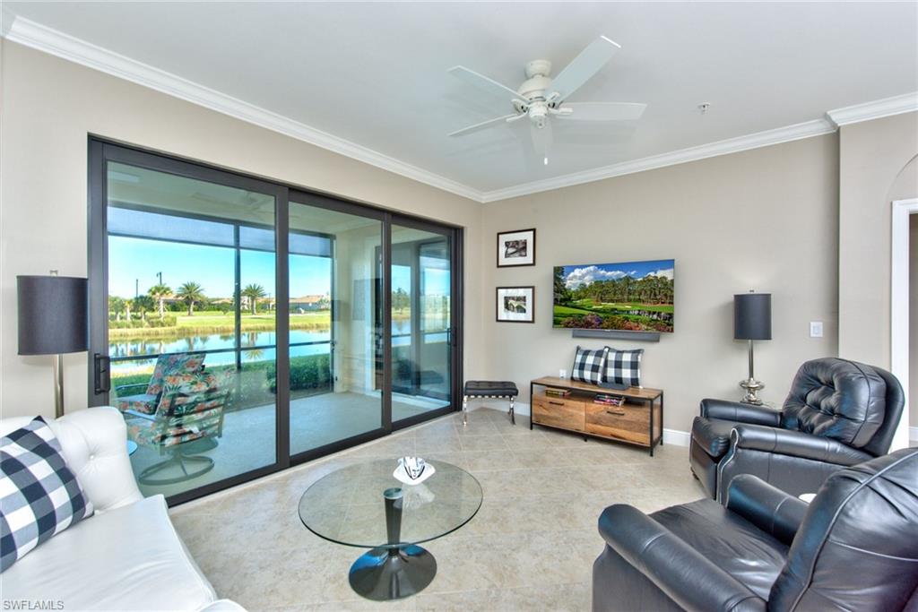 10470 Casella Way, Unit 101 Fort Myers, FL 33913 - Photo 9 of 34 a living room with furniture and a floor to ceiling window