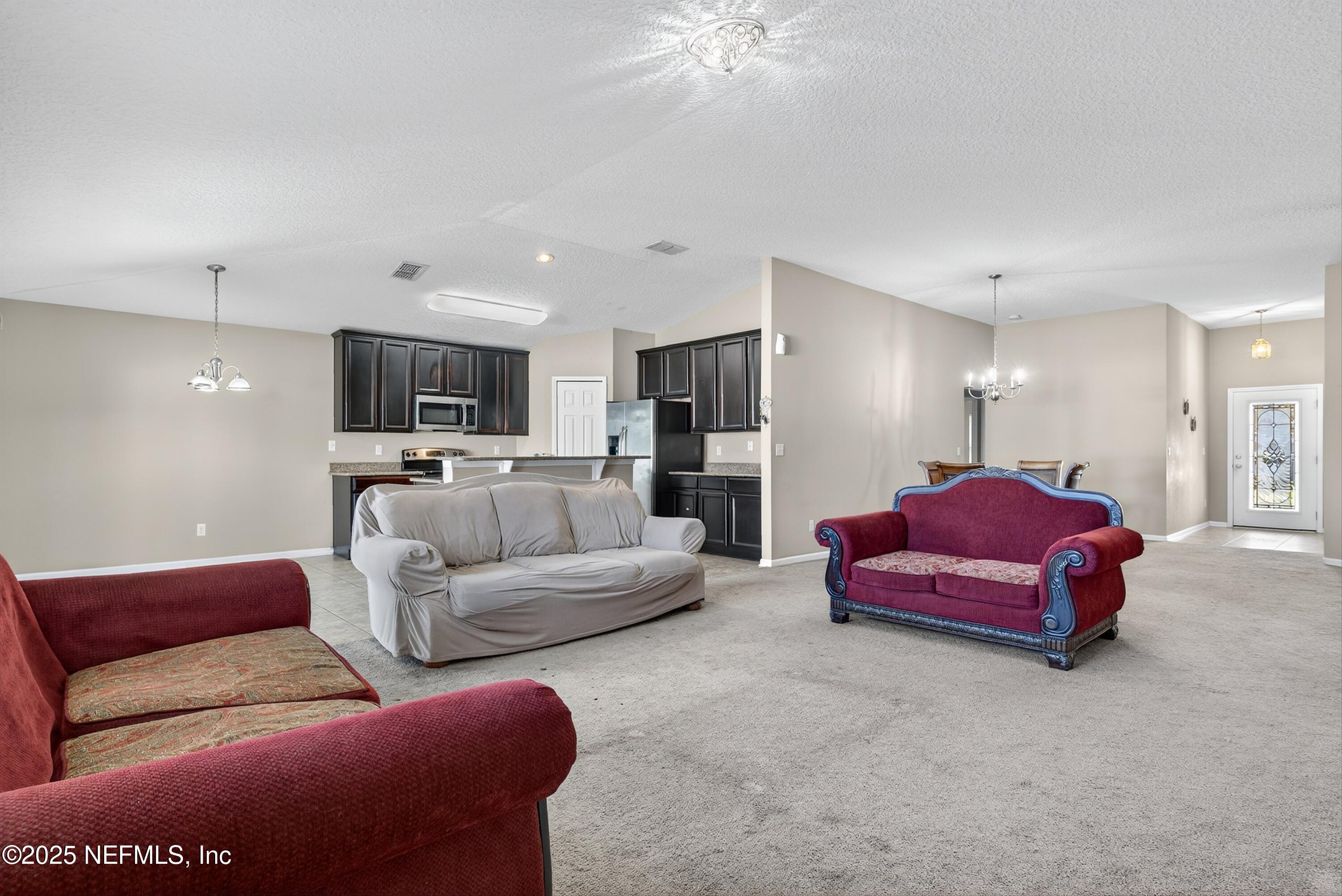 4045 Trail Ridge Road Middleburg, FL 32068 - Photo 13 of 45 a living room with furniture and a flat screen tv