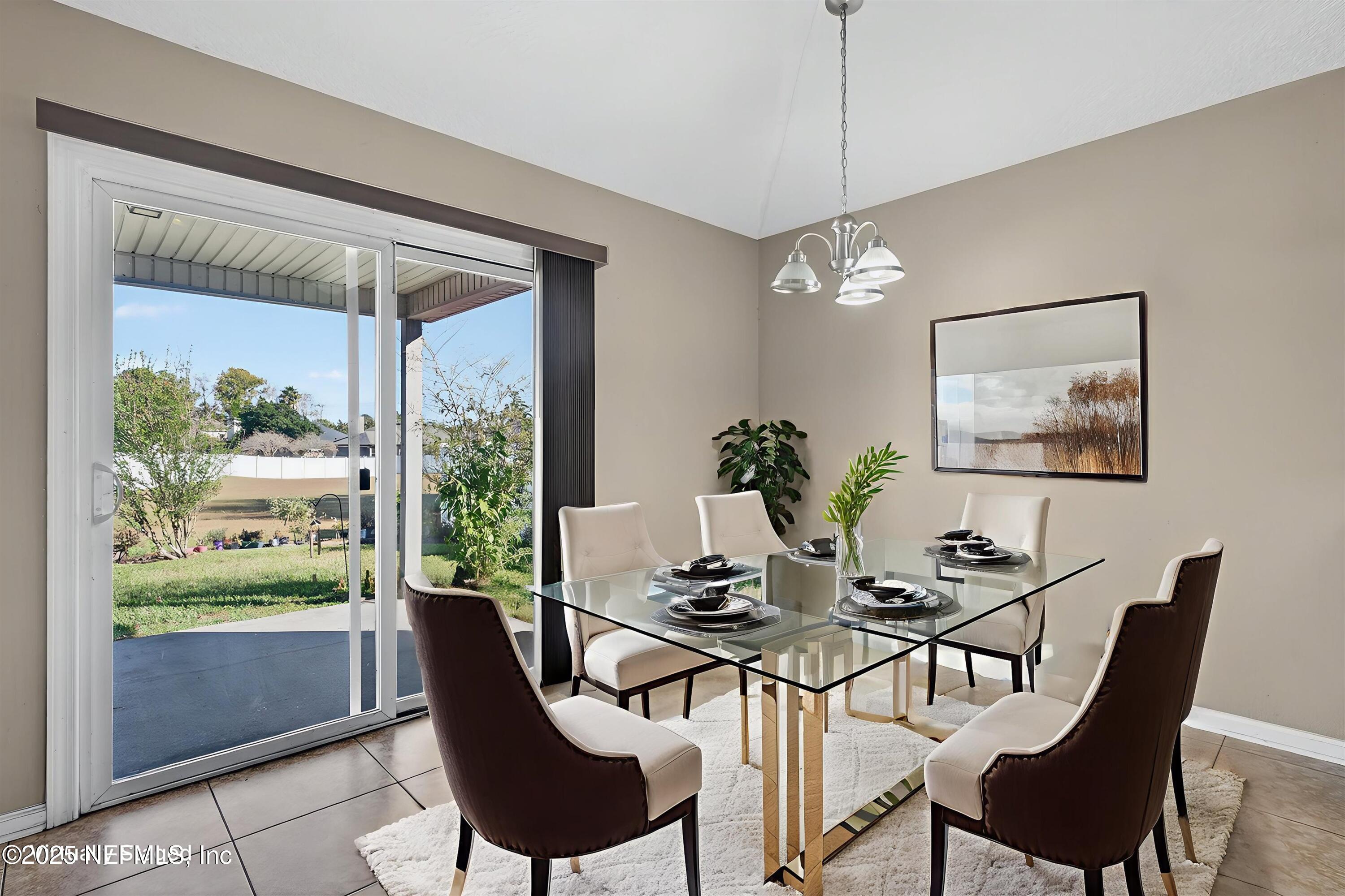 4045 Trail Ridge Road Middleburg, FL 32068 - Photo 19 of 45 a dining room with furniture a painting and a potted plant