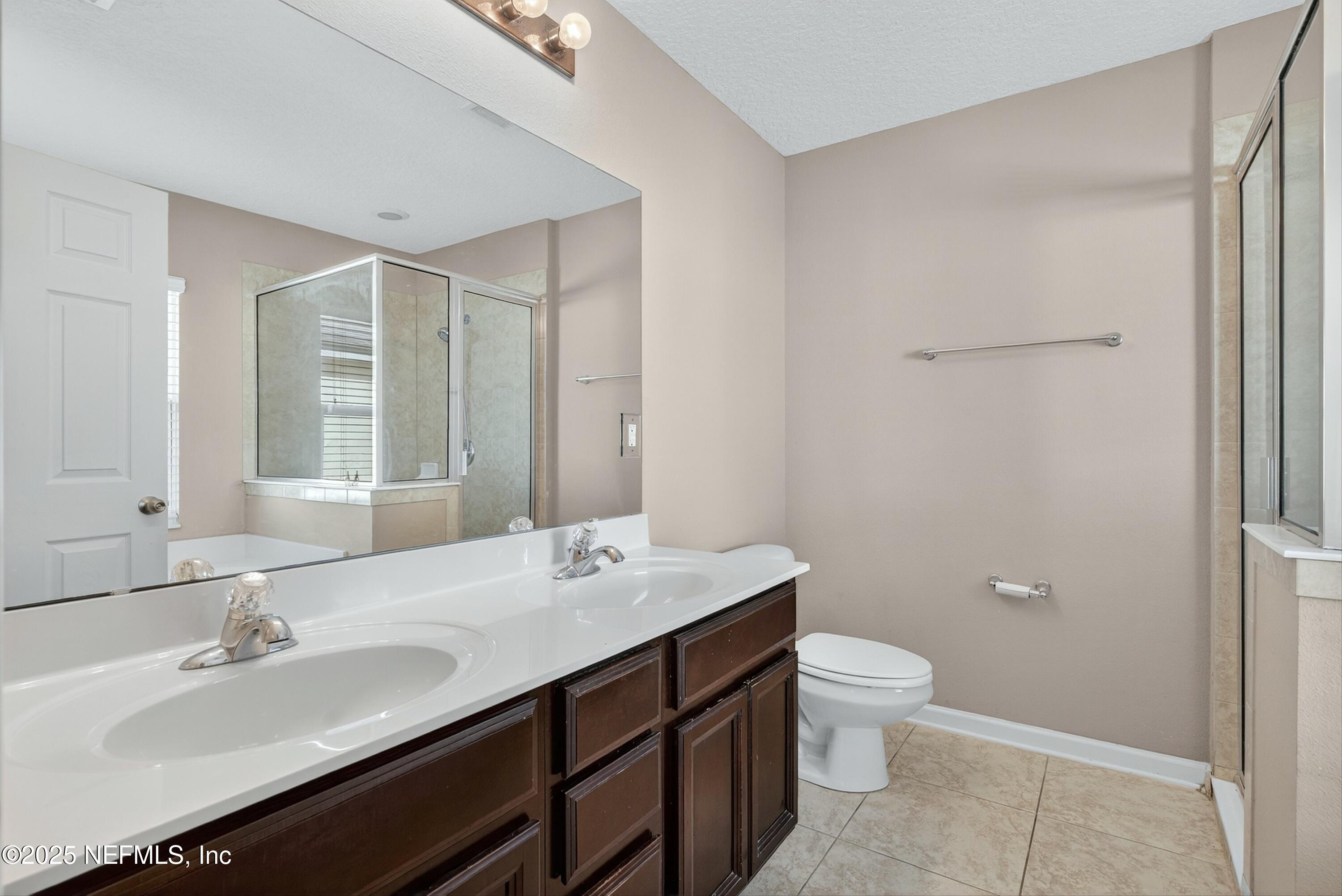 4045 Trail Ridge Road Middleburg, FL 32068 - Photo 24 of 45 a bathroom with a double vanity sink toilet and a mirror