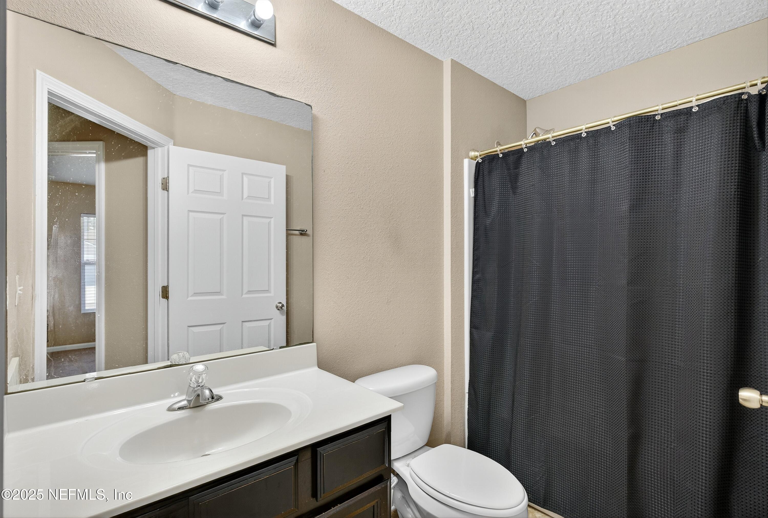 4045 Trail Ridge Road Middleburg, FL 32068 - Photo 29 of 45 a bathroom with a sink a toilet a mirror and shower