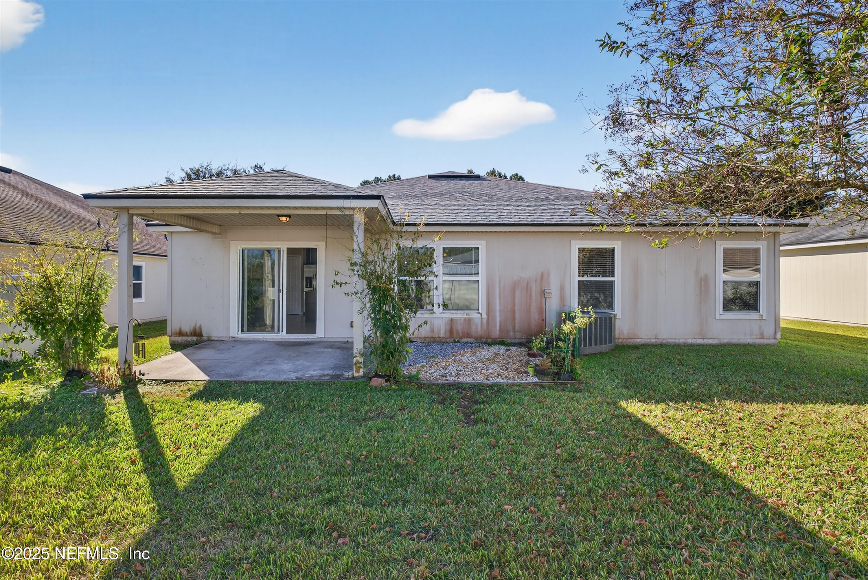 4045 Trail Ridge Road Middleburg, FL 32068 - Photo 36 of 45 a view of a house with a yard and table and potted plants