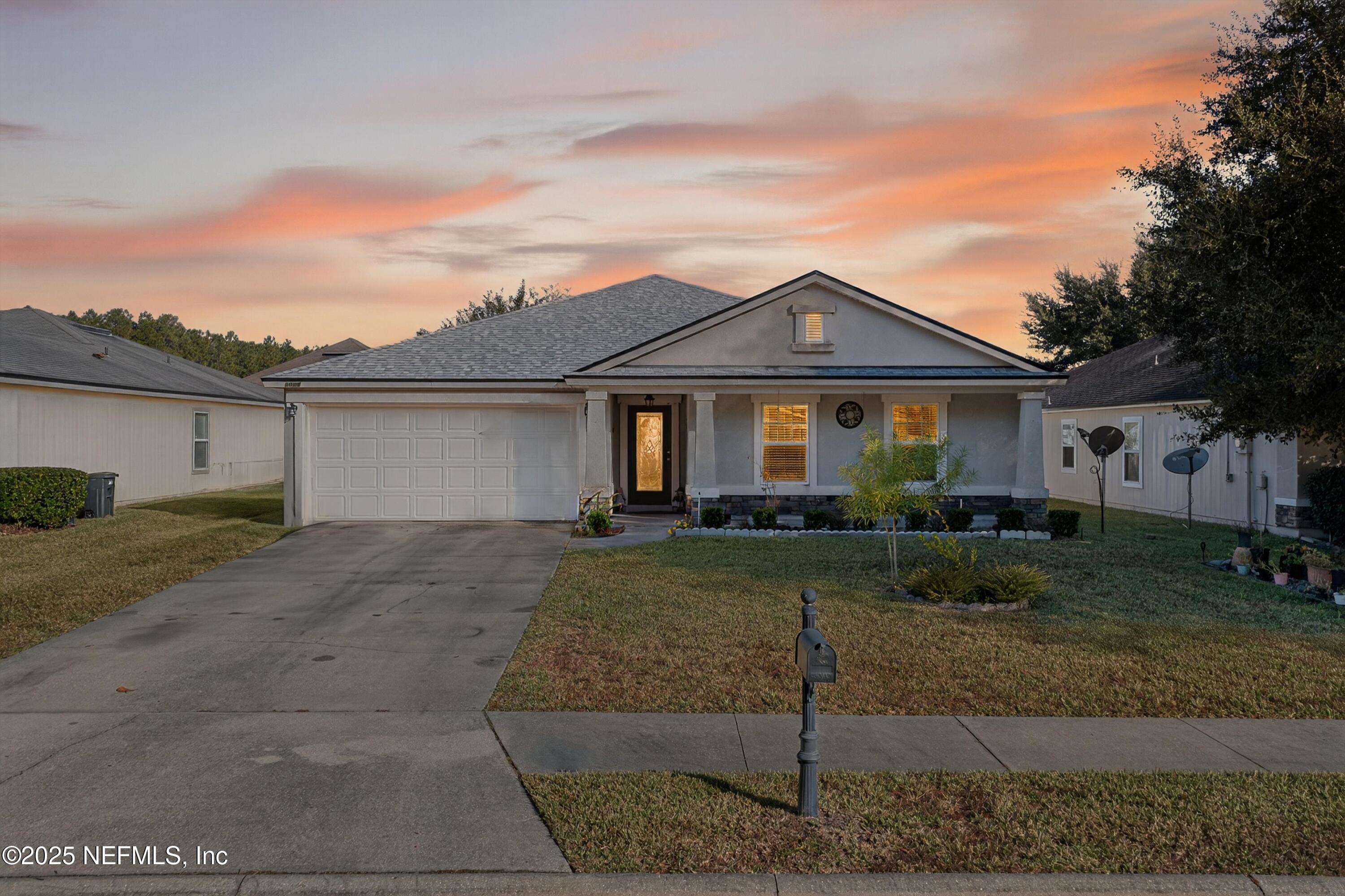 4045 Trail Ridge Road Middleburg, FL 32068 - Photo 44 of 45 a front view of a house with a yard and garage