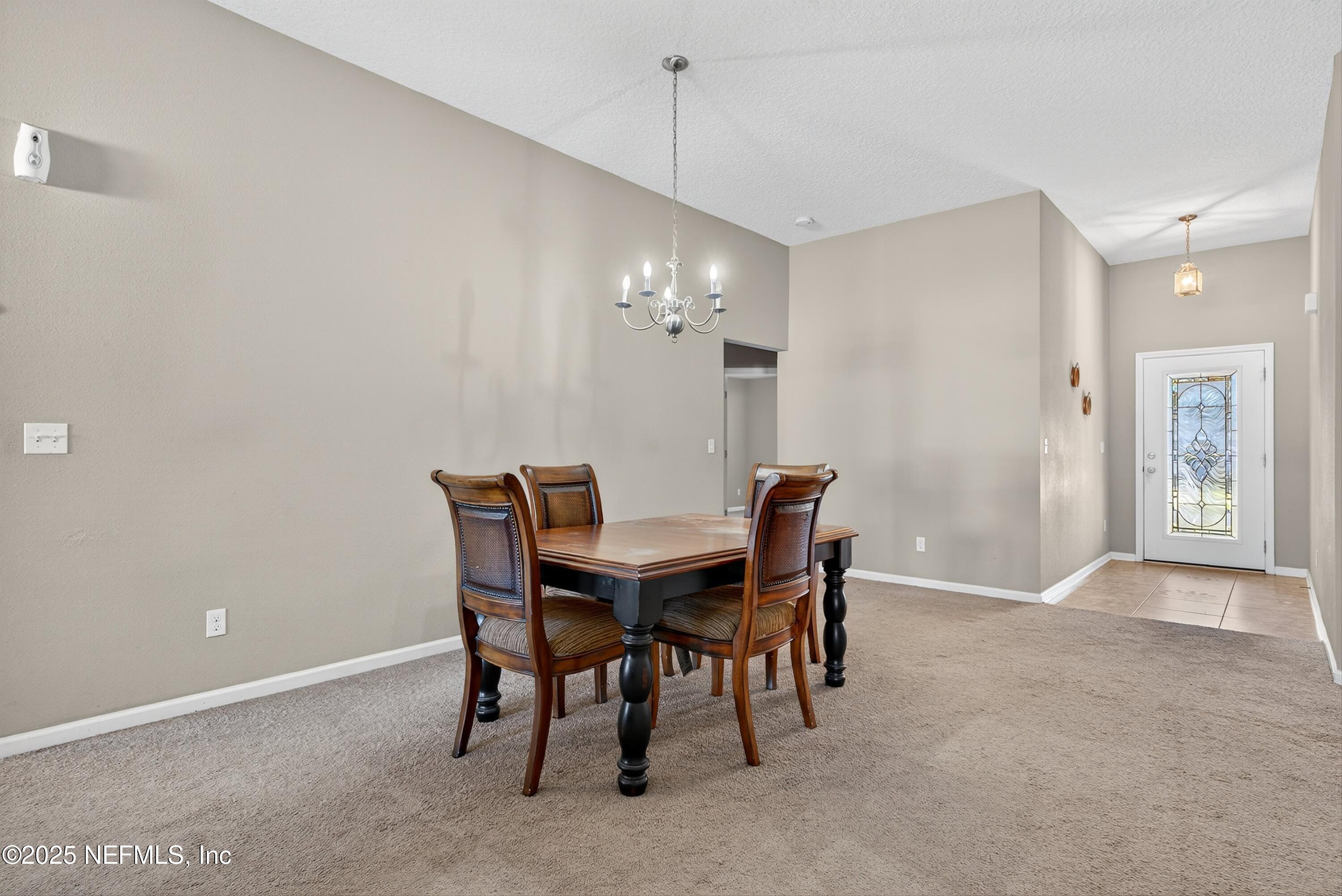 4045 Trail Ridge Road Middleburg, FL 32068 - Photo 8 of 45 a view of a dining room with furniture and chandelier