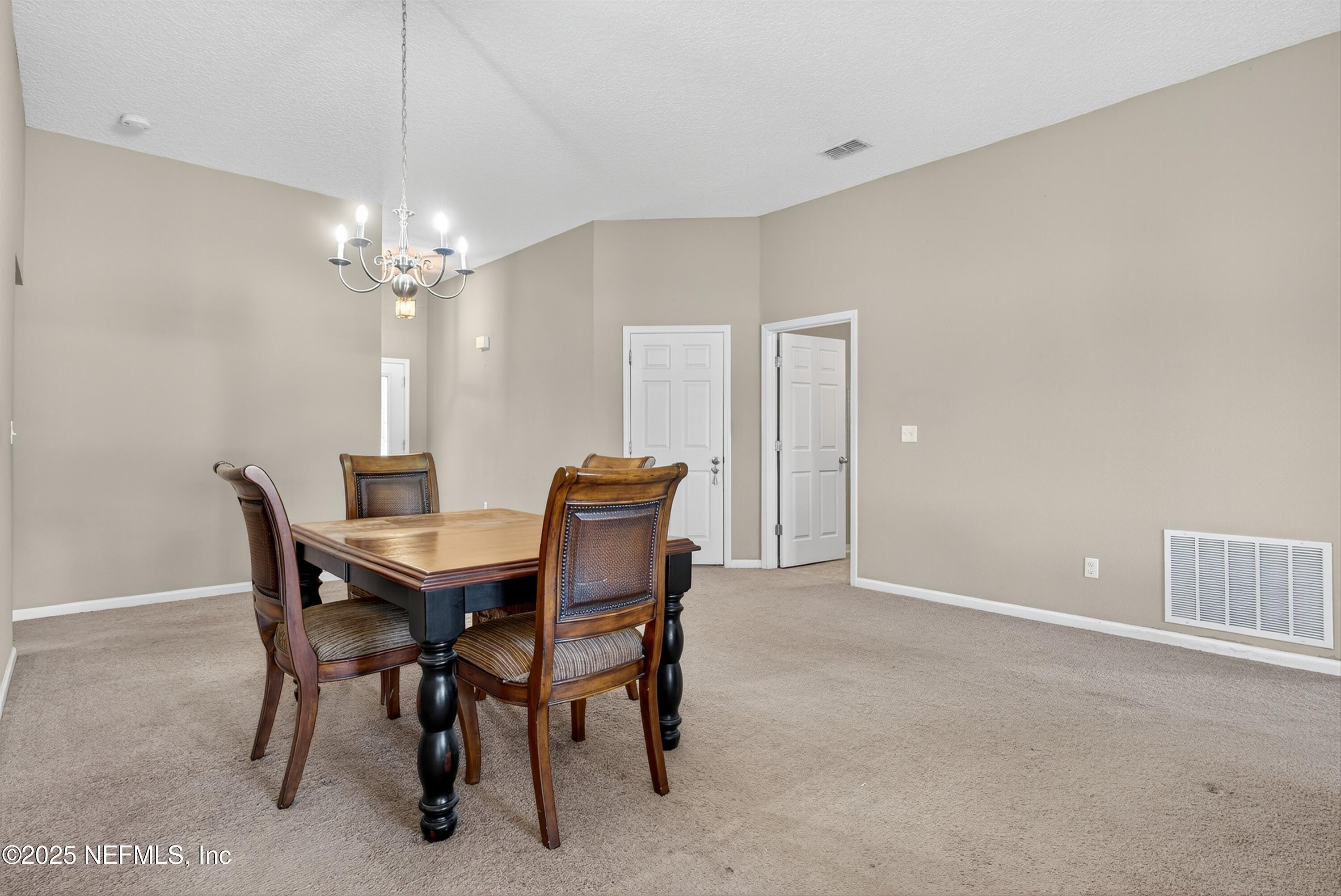 4045 Trail Ridge Road Middleburg, FL 32068 - Photo 9 of 45 a view of a dining room with furniture and chandelier