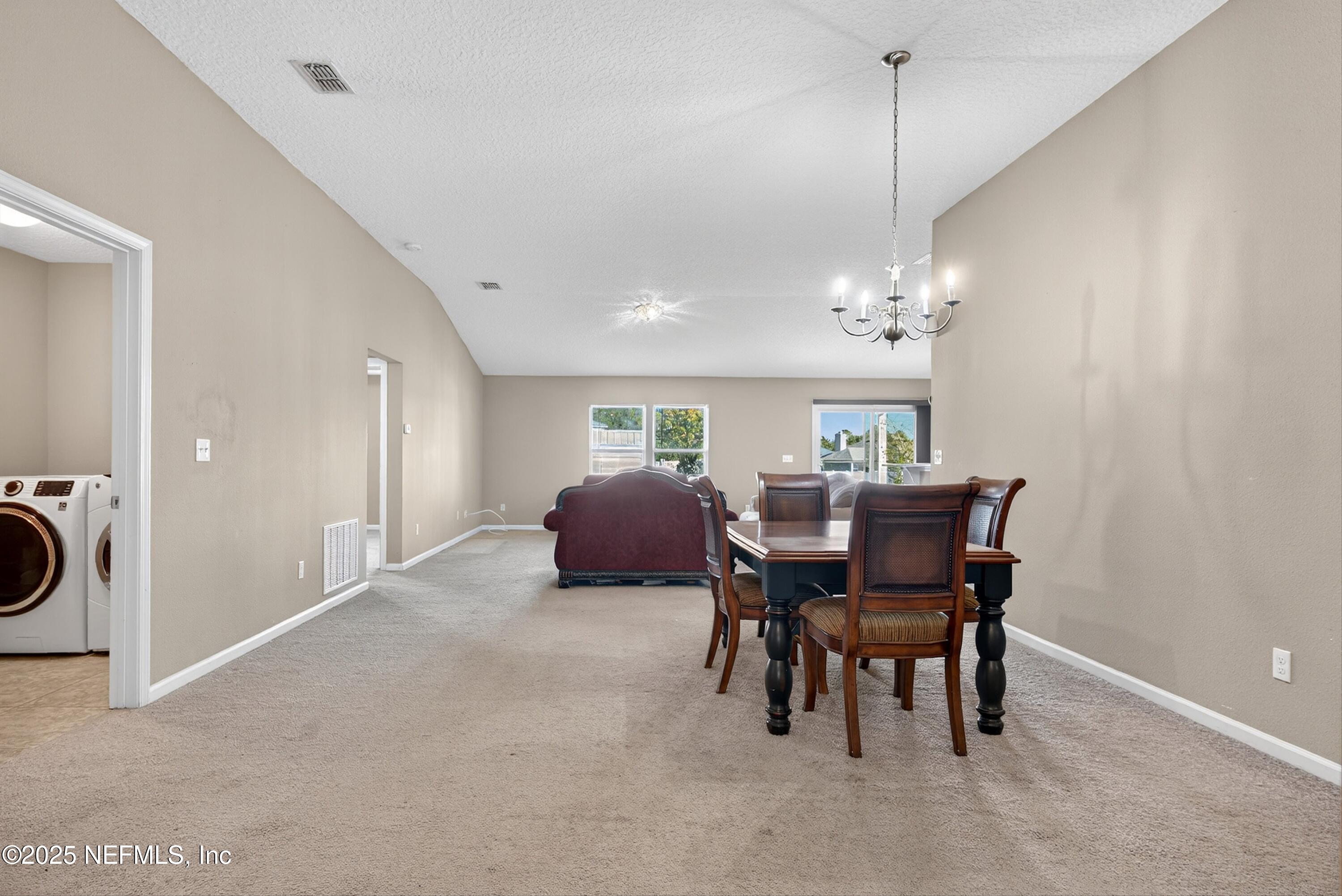 4045 Trail Ridge Road Middleburg, FL 32068 - Photo 10 of 45 a view of a dining room with furniture and chandelier