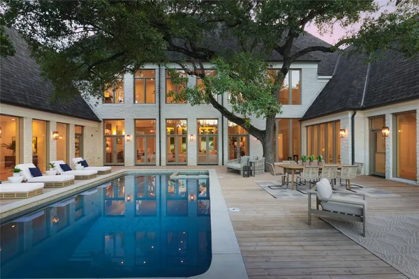 a living room with patio furniture and a large tree