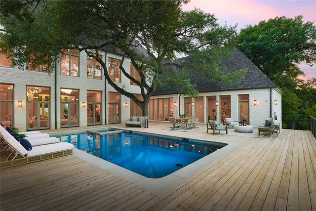a view of a patio with couches chairs and wooden floor