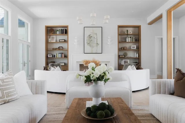 a living room with furniture and large windows