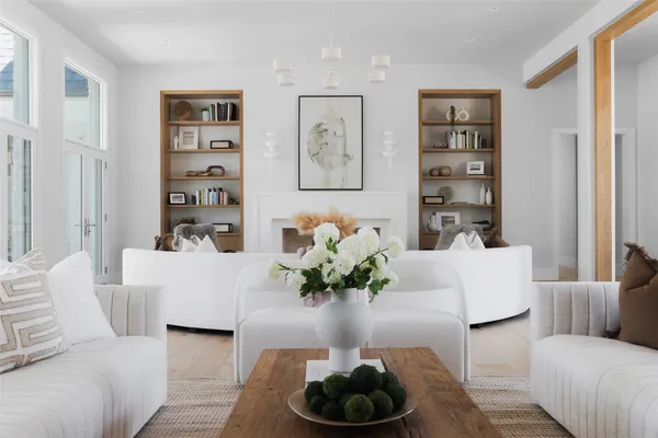 a living room with furniture and large windows