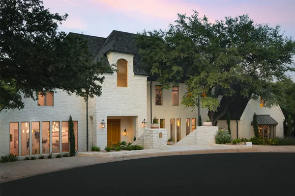 a front view of a house with a street