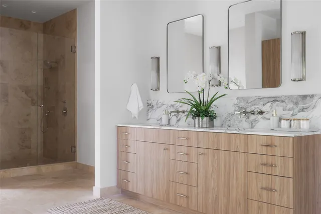 a bedroom with a bed a mirror and a night stand