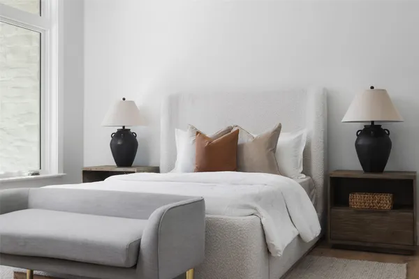 a bedroom with a bed and wooden floor