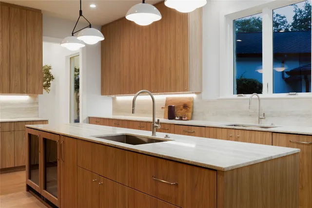 a kitchen with stainless steel appliances granite countertop a sink a counter space and cabinets