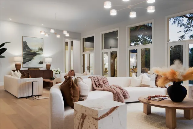 a living room with furniture potted plant and a large mirror