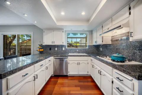 a large kitchen with stainless steel appliances lots of counter space sink and cabinets