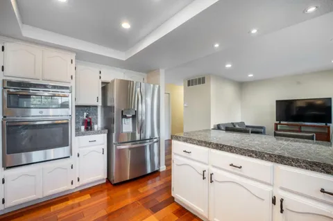a kitchen with granite countertop stainless steel appliances and counter space