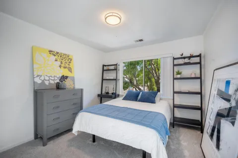 a bedroom with a bed and a window