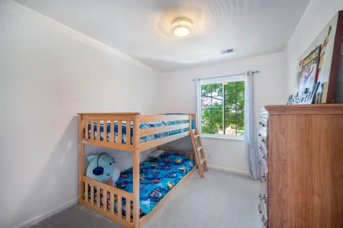 a bedroom with furniture and a window