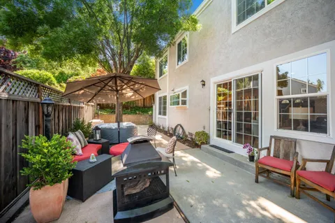 a view of a chairs and table in backyard of the house