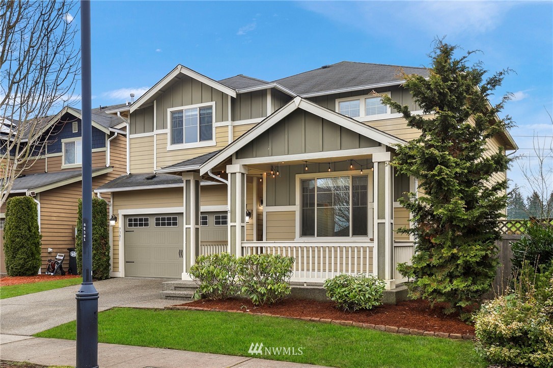 a view of a brick house with a yard and large trees